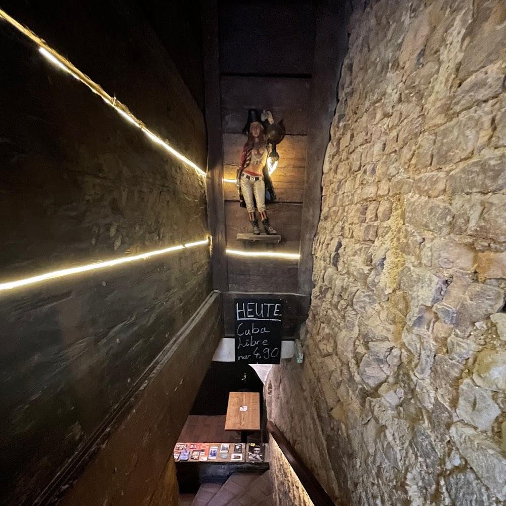 A brick staircase with a wooden wall and a pirate statue.